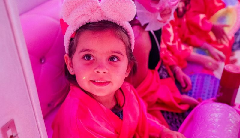 Little girls getting mini manicures during a Glam N' Party spa party in Miami